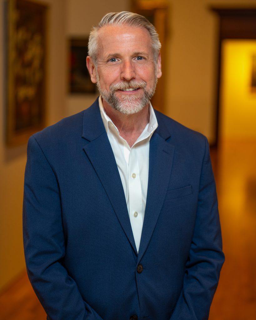 Bob Burns in a white shirt with blue jacket