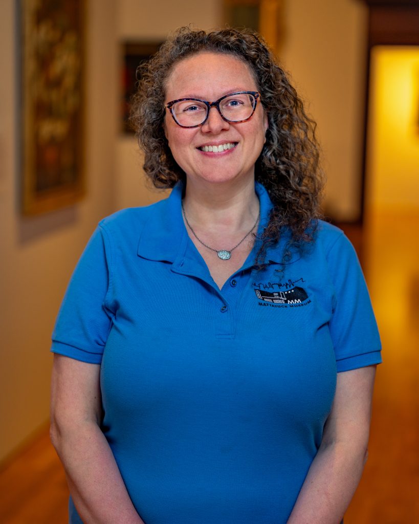 Jaimie Cura in a blue Mattatuck shirt with glasses