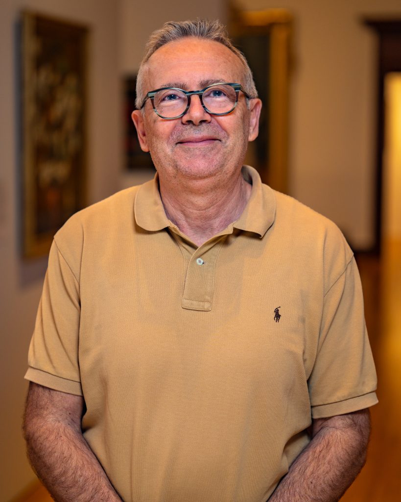 Randy Selenica in a tan shirt wearing glasses