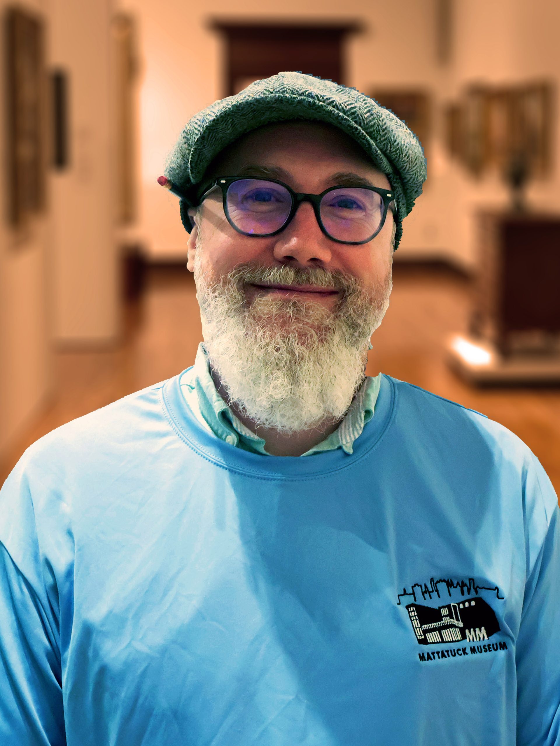 Lyle Cairdeas in a blue Mattatuck shirt and cap with glasses and beard.